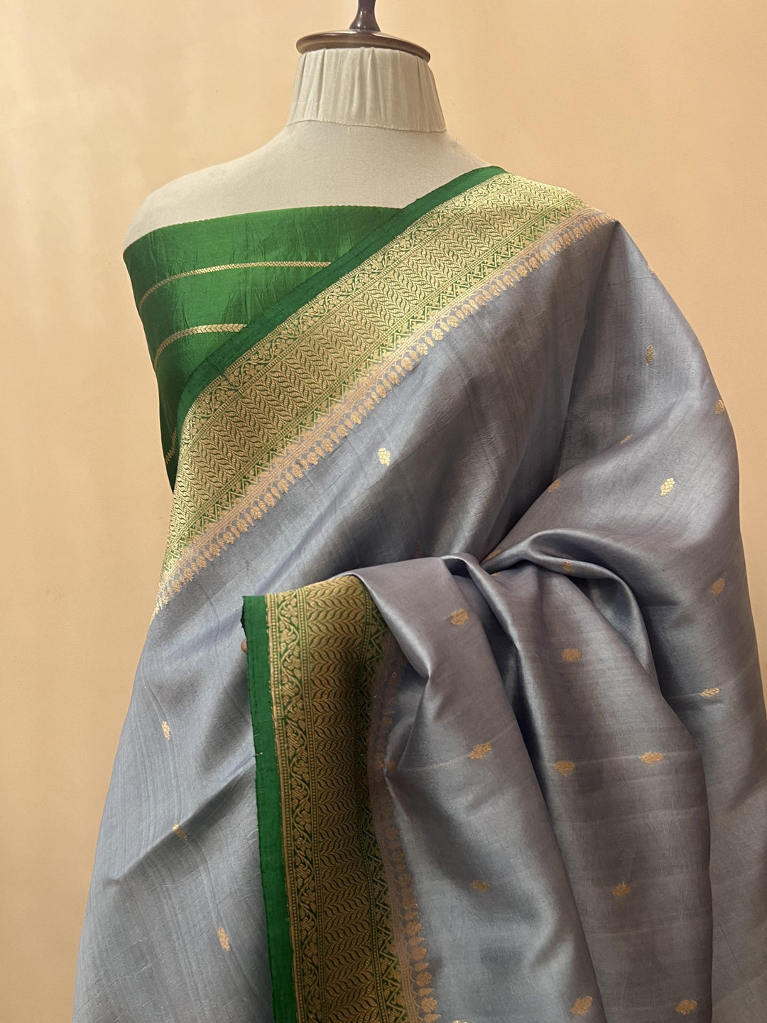 Pure silk handloom Banarasi saree draped with contrast Kadhwa borders and butis, featuring elegant handwoven craftsmanship