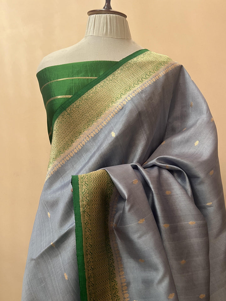 Pure silk handloom Banarasi saree draped with contrast Kadhwa borders and butis, featuring elegant handwoven craftsmanship