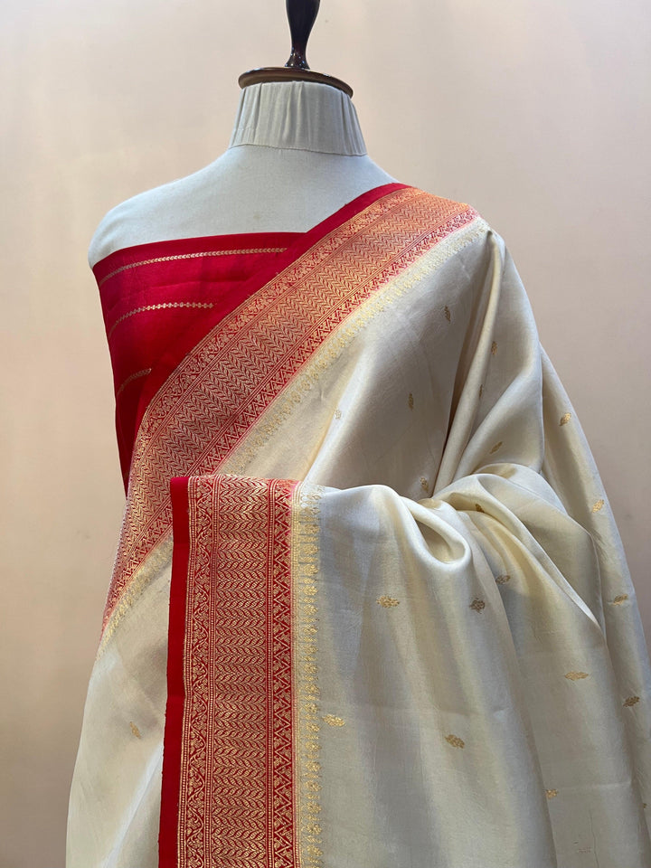 Pure silk handloom Banarasi saree draped with contrast Kadhwa borders and butis, featuring elegant handwoven craftsmanship