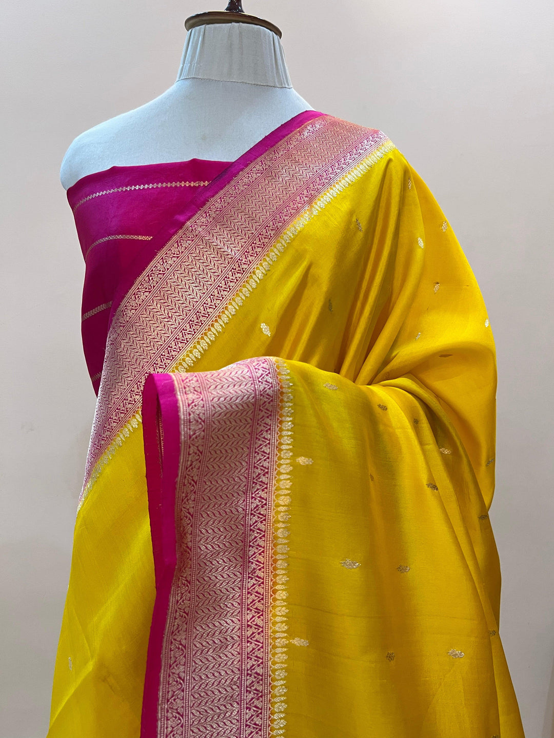 Pure silk handloom Banarasi saree draped with contrast Kadhwa borders and butis, featuring elegant handwoven craftsmanship