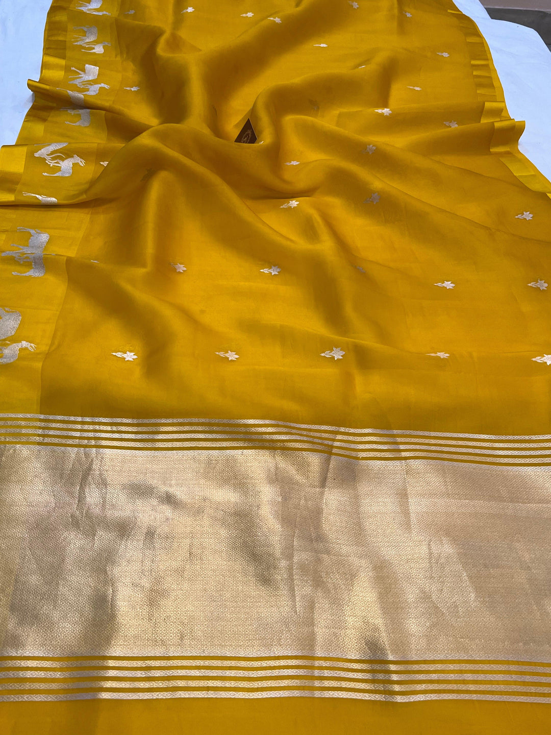 Pure Kora silk handloom Banarasi saree draped with Kadhwa Sona Rupa butis, Mashru silk border featuring hiran motifs, and elegant designer pallu