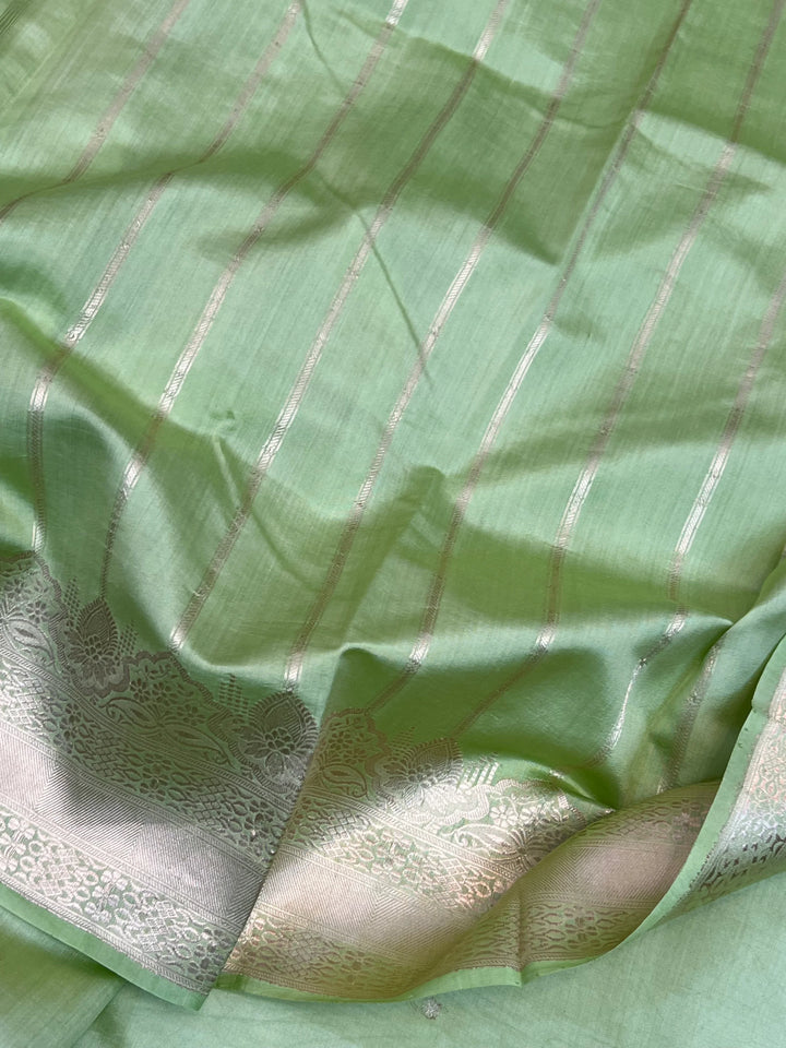 Striped blouse piece paired with the Pista Green Banarasi silk saree