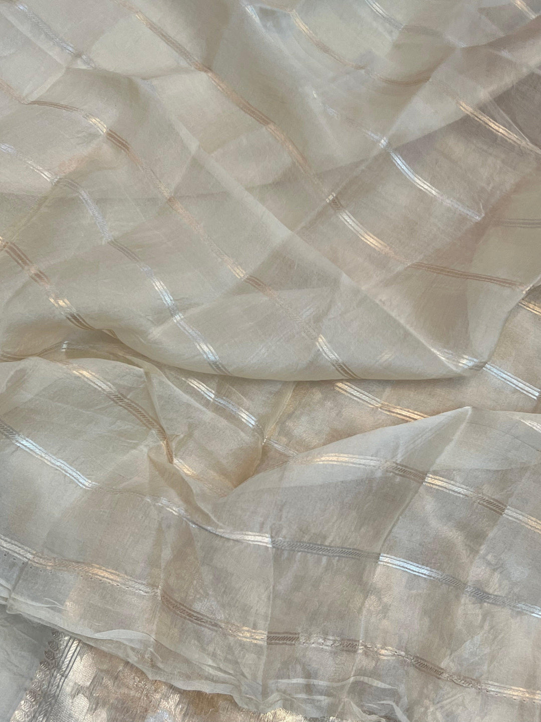 Blouse piece with golden zari lines included with the pure Kora silk Banarasi saree