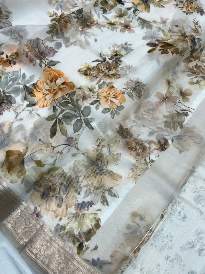 Graceful pallu of Kora silk saree featuring floral print and silver zari detailing