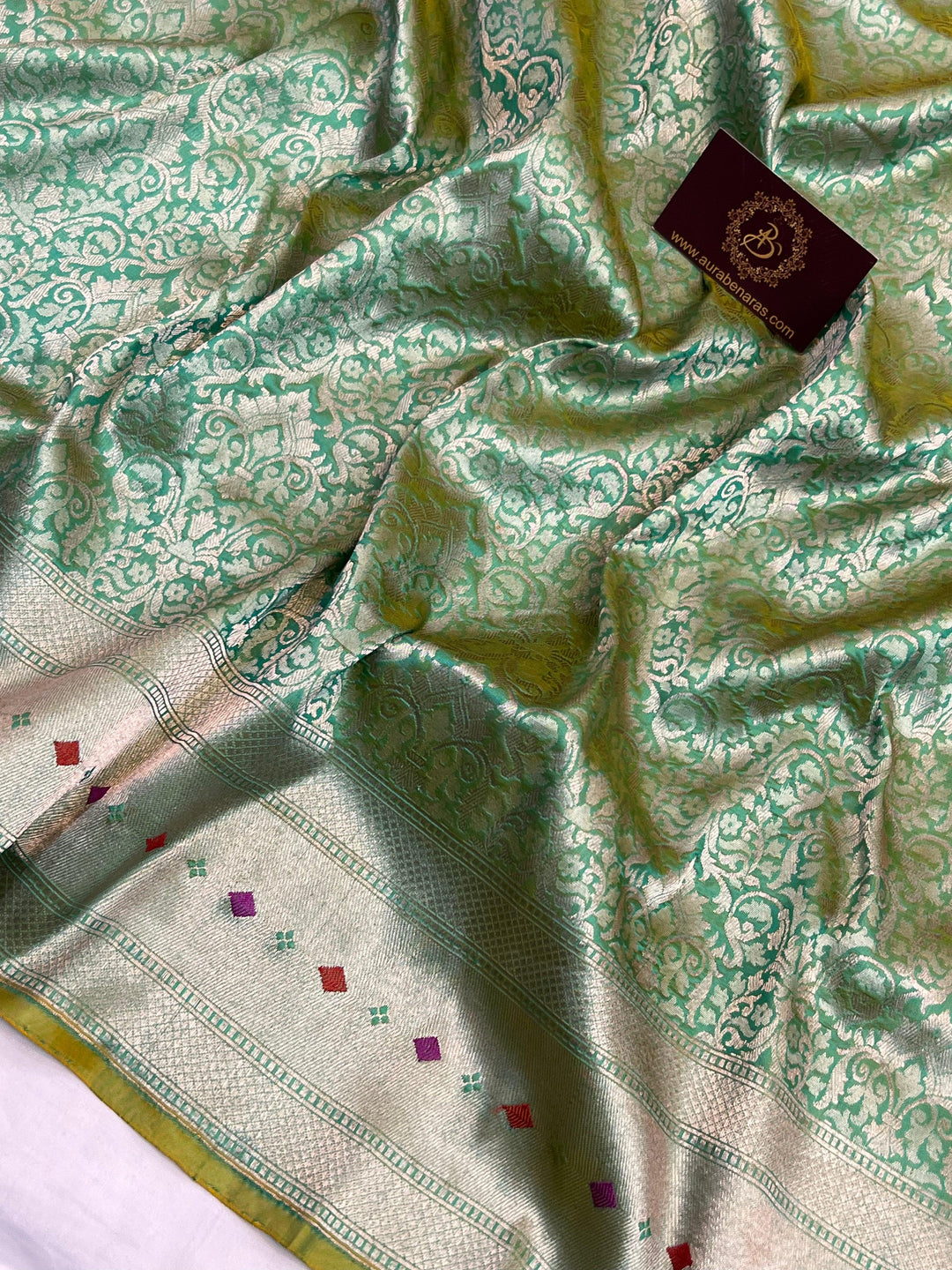 Golden zari geometric brocade work on pure Katan silk Banarasi saree with Meenakari border