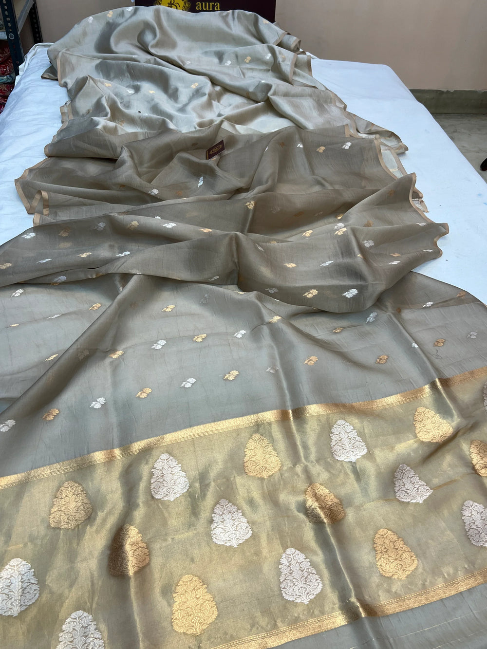 Pallu of Banarasi saree in shimmering tissue silk with golden zari work