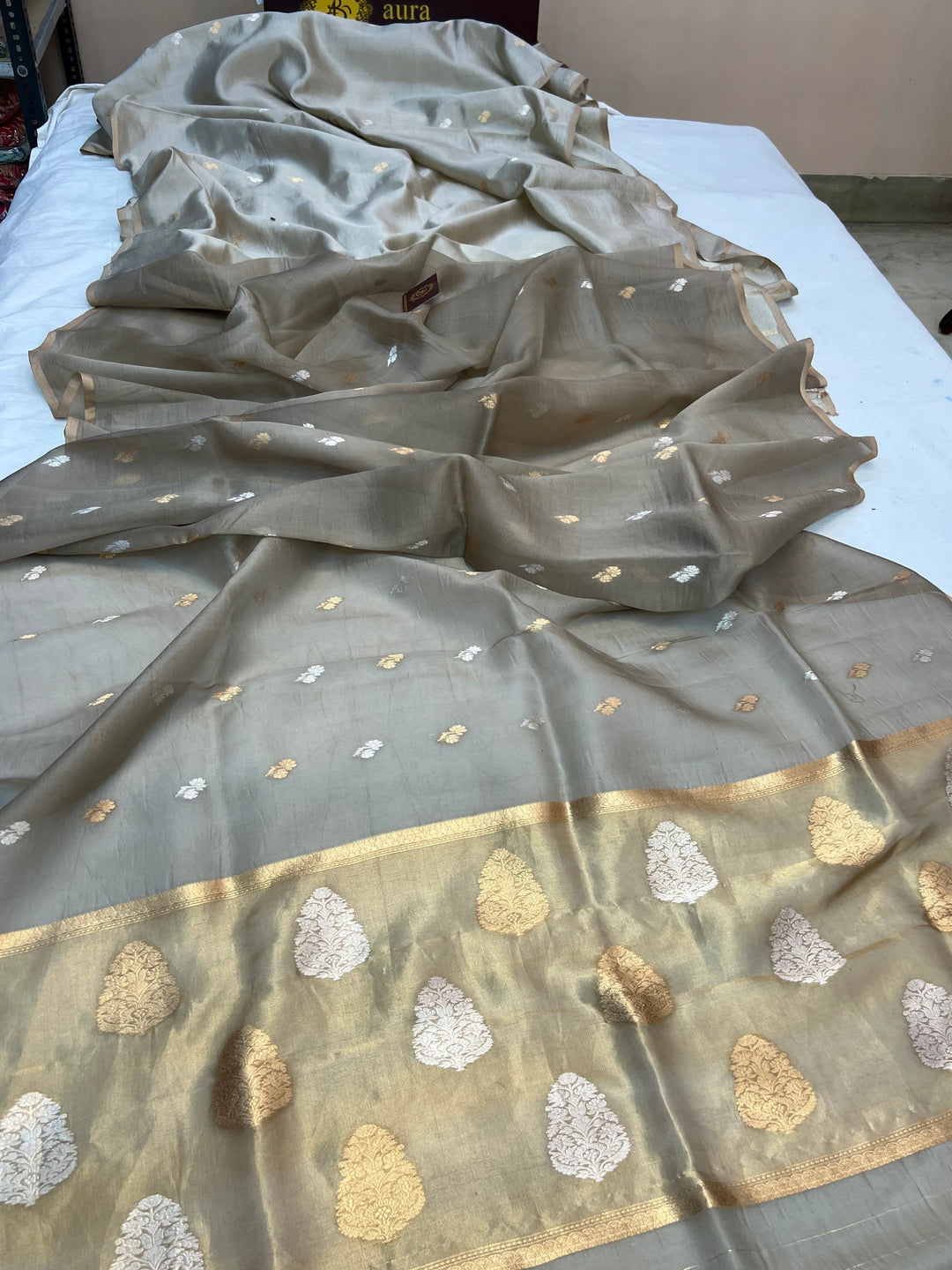 Pallu of Banarasi saree in shimmering tissue silk with golden zari work