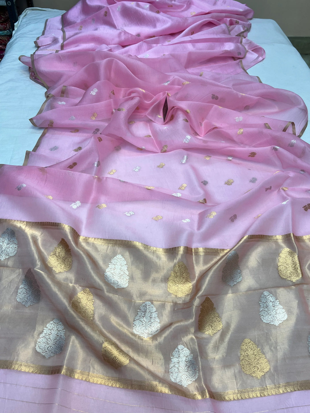 Pallu of Banarasi saree in shimmering tissue silk with golden zari work