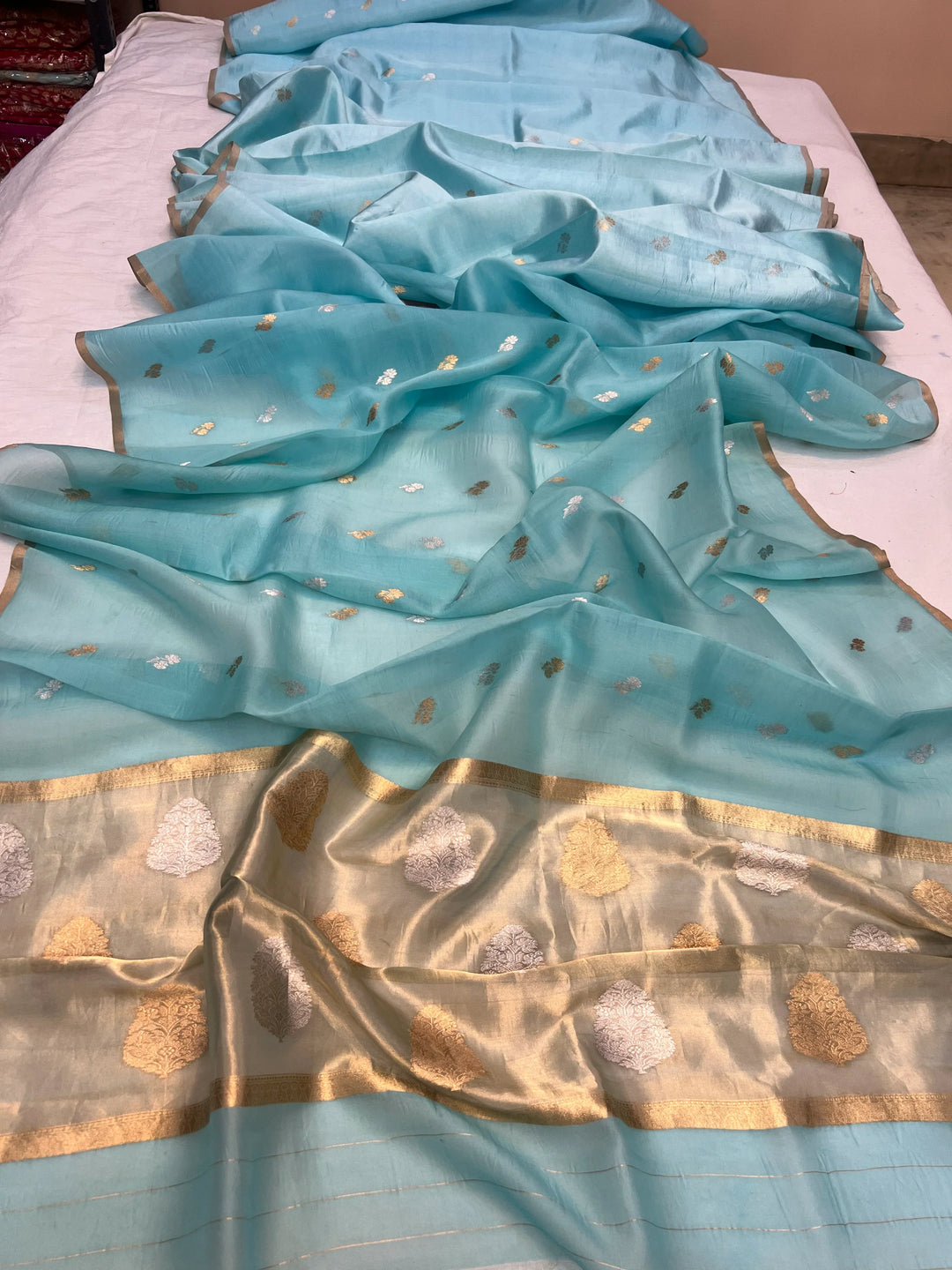 Pallu of Banarasi saree in shimmering tissue silk with golden zari work
